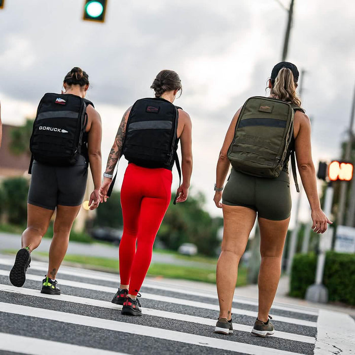 Three women rucking with GORUCK backpacks crosswalk outdoors fitness lifestyle