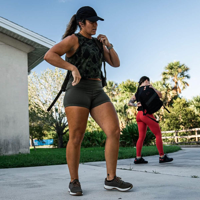 Women wearing GORUCK gear and backpacks outdoors, ready for rucking exercise