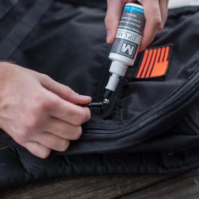 Applying McNett Zip Care to a GORUCK black backpack zipper for gear maintenance
